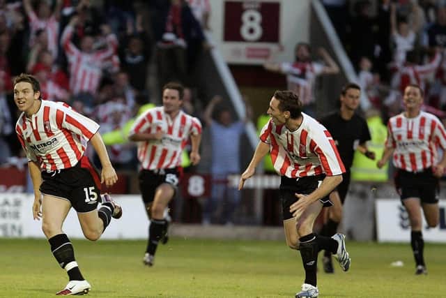 Kevin Deery and Barry Molloy race towards the travelling Derry fans to celebrate.