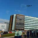 Staff look on as the THANK U NHS Spitfire flies over Altnagelvin Hospital on Thursday afternoon. DER2038GS – 049