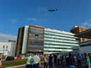 Staff look on as the THANK U NHS Spitfire flies over Altnagelvin Hospital on Thursday afternoon. DER2038GS – 049