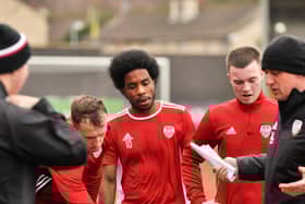Walter Figueira listens to instructions from Derry boss, Declan Devine.