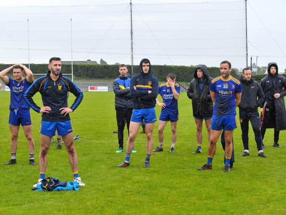 Devastated Steelstown players watch on as Greenlough lift the Derry Intermediate title in Bellaghy on Sunday.