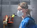 Artist Peter Barber works on a mural in Manchester city centre, depicting nurse Melanie Senior, after The National Portrait Gallery commissioned the mural based on a photograph by Johannah Churchill