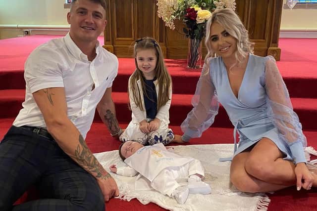 FAMILY MAN  . . .  Connor Coyle pictured with his girlfriend, Eva, and his daughter, Clodagh-Rose, at his son Cálaeb’s christening.