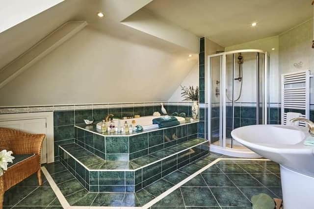 The bathroom has a range of featurees including a sunken jacuzzi bath