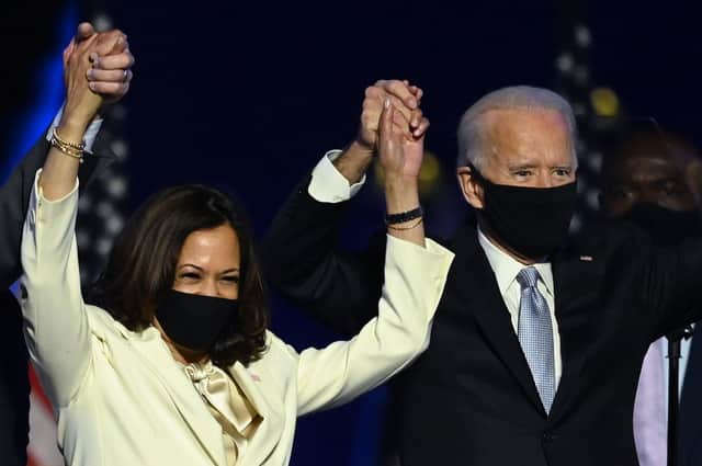 US President-elect Joe Biden and Vice President-elect Kamala Harris stand onstage after delivering remarks in Wilmington, Delaware, on November 7, 2020, after being declared the winners of the presidential election. (Photo by Jim WATSON / AFP) (Photo by JIM WATSON/AFP via Getty Images)