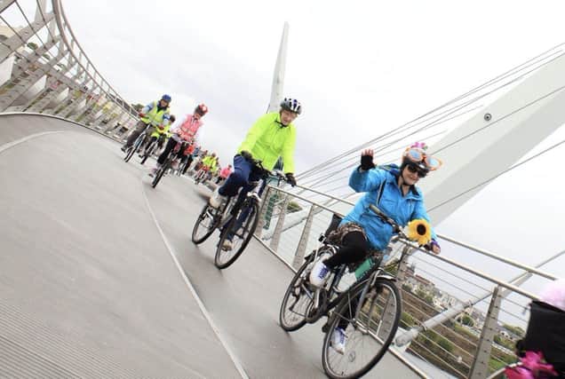 A group of cyclists under guidance from Cycling Made Easy's Monica Downey, making their way through Derry's Peace Bridge.