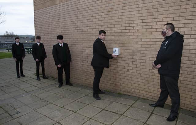 SCHOOL RETURN. . . . .Mr. Gerry Beattie, Senior Teacherl, St. Josephâ€TMs Boys School ensuring Year 12 students actively hand sanitise before entering the school yesterday morning as Year 12 and 14 students returned to the school. (Photos: jim McCafferty Photography)