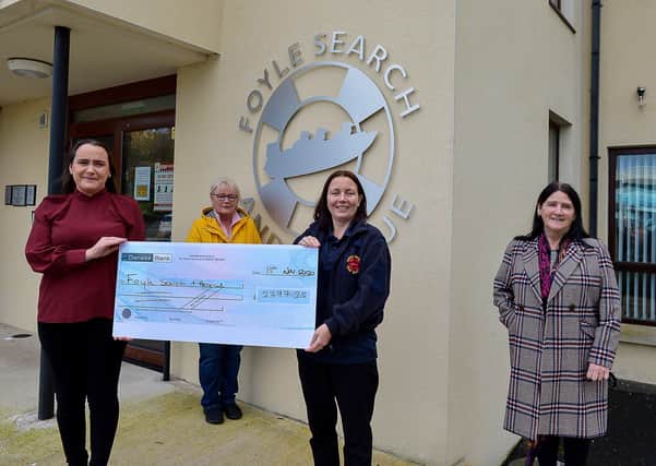 Fiona McDaid, who raised £2797.25 to Christina McKeegan, Foyle Search and Rescue, the proceeds from a Sober October fund raising event organised by Fiona and supported by friends and family. Included in the photograph are Margaret Doherty and Mary Forbes.  DER2046GS - 006
