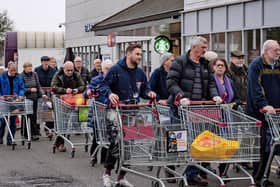 Shoppers queue outside a supermarket in the early days of the Covid-19 pandemic.