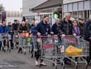 Shoppers queue outside a supermarket in the early days of the Covid-19 pandemic.