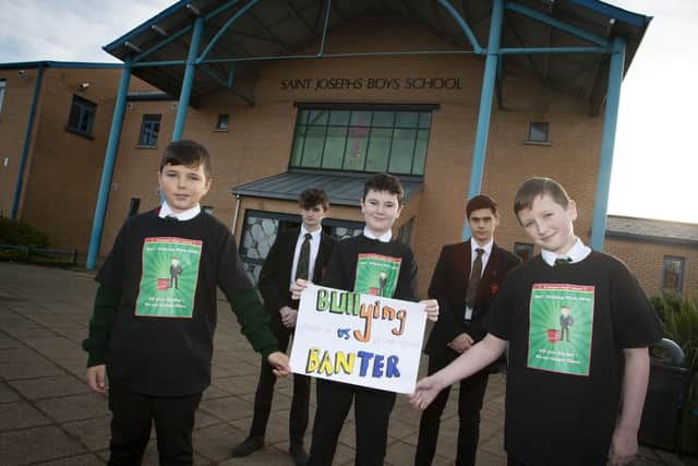 Year 14 students James Crampsey and Matthew Devine showing their support to Year 8 pupils Andrew Cregan, Jamie Smith and Conan Oâ€TMKane as St. Josephâ€TMs marked Anti Bullying Week at the school.