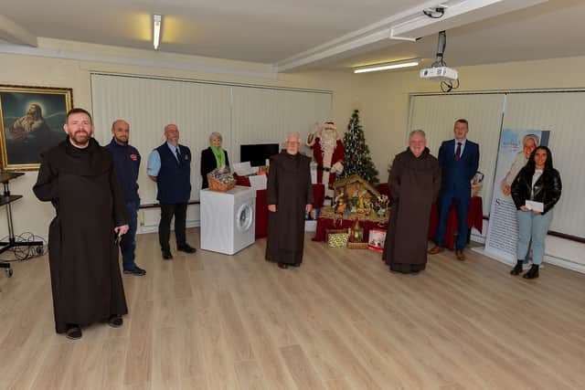 Group pictured at the recent presentation of donations, from local businesses, to the Carmelite Fathers, Termonbacca Monastery, for their annual Christmas draw.  From left are Fr, Stephen ODC, Prior, Peter Doherty, Furniture Plus, Tommy Mooreland, City Cabs, Marian Simpson, Bowling Alley, Fr. Edmond ODC, Santa, Fr. Michael ODC, Owen McNicholl, Flo Gas, and Jessica McMenamin, All Pipe. DER2048GS - 008