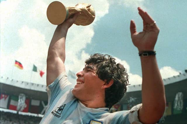 Diego Maradona lifts the Jules Rimet Trophy