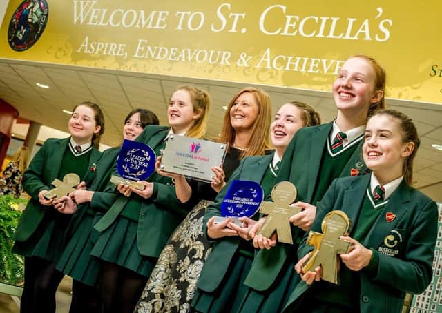 What an achievement!.... St Cecilia's Principal Martine Mulhern with pupils showcasing some of their previous awards.