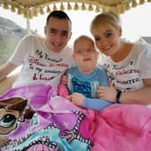 Hollie with her dad Ciaran and mum Laura on a carriage ride to her belated sixth birthday party. Hollie spent her actual birthday in hospital.