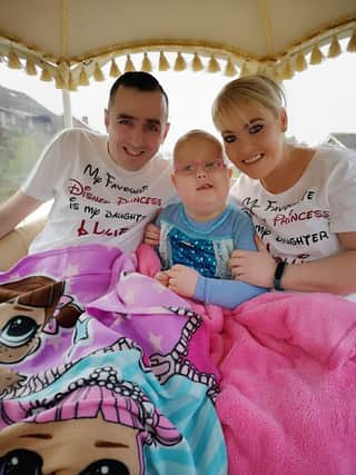 Hollie with her dad Ciaran and mum Laura on a carriage ride to her belated sixth birthday party. Hollie spent her actual birthday in hospital.