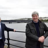 Translink's John Glass and Joe Mahon with the Craigavon Bridge in the background.