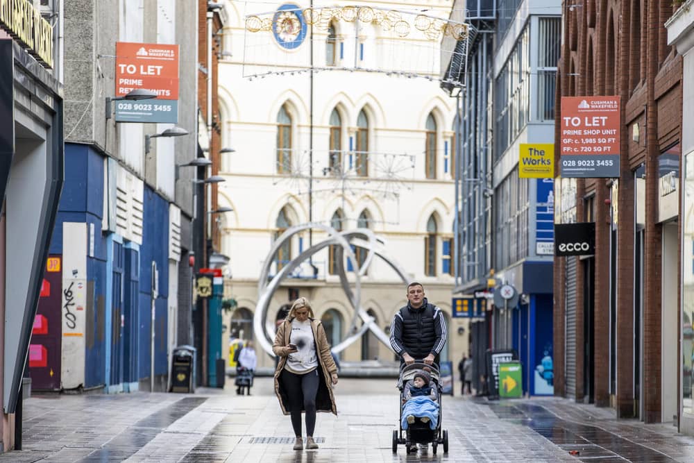 People walking along Castle Lane in Belfast.