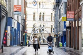 People walking along Castle Lane in Belfast.