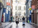 People walking along Castle Lane in Belfast.