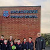 Faughanvale senior men’s team manager, Joe Gray (right) is pictured with Daniel McLaughlin, principal, Broadbridge Primary School, and pupils from the school with just some of the equipment donated by the club.