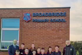Faughanvale senior men’s team manager, Joe Gray (right) is pictured with Daniel McLaughlin, principal, Broadbridge Primary School, and pupils from the school with just some of the equipment donated by the club.