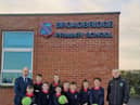 Faughanvale senior men’s team manager, Joe Gray (right) is pictured with Daniel McLaughlin, principal, Broadbridge Primary School, and pupils from the school with just some of the equipment donated by the club.
