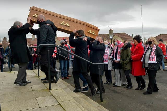 Derry City manager Declan Devine helps carry the coffin of Hugh Curran into St Mary’s Church Creggan, for Requiem Mass, on Wednesday morning. Photo: George Sweeney / Derry Journal  DER2050GS –  035