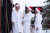 Gordon, Gino and Fred walk through the snow in  dressing gowns as they head for a sauna