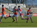 Derry's Peter McCullagh nips in ahead of two Armagh defenders during the Oak Leafers' championship victory in Owenbeg on Sunday.