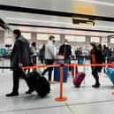 Passengers queue for check-in at Gatwick Airport in West Sussex, amid concerns that borders will close and with the public being urged to adhere to Government guidance after Prime Minister Boris Johnson announced on Saturday that from Sunday areas in the South East currently in Tier 3 will be moved into a new Tier 4 for two weeks - effectively returning to the lockdown rules of November, after scientists warned of the rapid spread of the new variant coronavirus.