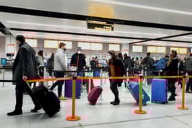 Passengers queue for check-in at Gatwick Airport in West Sussex, amid concerns that borders will close and with the public being urged to adhere to Government guidance after Prime Minister Boris Johnson announced on Saturday that from Sunday areas in the South East currently in Tier 3 will be moved into a new Tier 4 for two weeks - effectively returning to the lockdown rules of November, after scientists warned of the rapid spread of the new variant coronavirus.