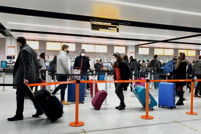 Passengers queue for check-in at Gatwick Airport in West Sussex, amid concerns that borders will close and with the public being urged to adhere to Government guidance after Prime Minister Boris Johnson announced on Saturday that from Sunday areas in the South East currently in Tier 3 will be moved into a new Tier 4 for two weeks - effectively returning to the lockdown rules of November, after scientists warned of the rapid spread of the new variant coronavirus.