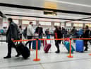 Passengers queue for check-in at Gatwick Airport in West Sussex, amid concerns that borders will close and with the public being urged to adhere to Government guidance after Prime Minister Boris Johnson announced on Saturday that from Sunday areas in the South East currently in Tier 3 will be moved into a new Tier 4 for two weeks - effectively returning to the lockdown rules of November, after scientists warned of the rapid spread of the new variant coronavirus.