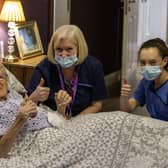 (left to right) 100-year-old Ethel Sinclair, with care staff Cathy Lacey and Lauren Adams, who was among residents to receive the coronavirus vaccine at Bradley Manor care home in north Belfast.