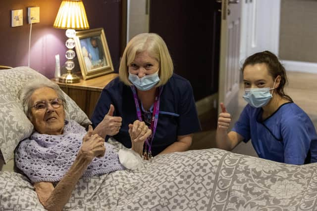 (left to right) 100-year-old Ethel Sinclair, with care staff Cathy Lacey and Lauren Adams, who was among residents to receive the coronavirus vaccine at Bradley Manor care home in north Belfast.