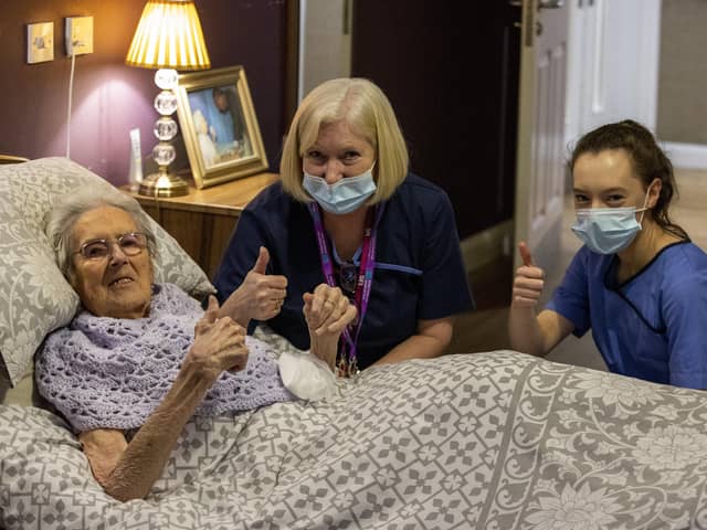 (left to right) 100-year-old Ethel Sinclair, with care staff Cathy Lacey and Lauren Adams, who was among residents to receive the coronavirus vaccine at Bradley Manor care home in north Belfast.