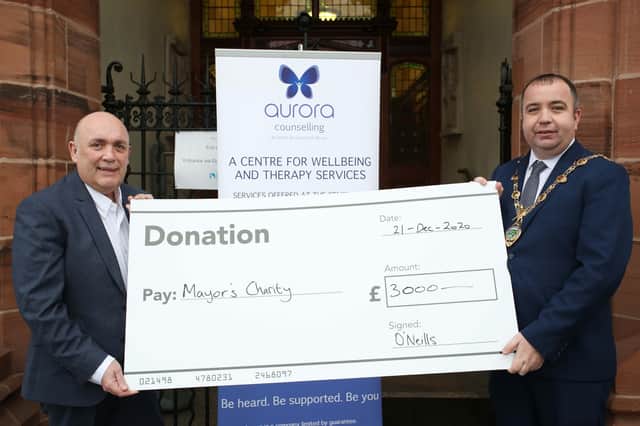 Kieran Kennedy, Managing Director of O’Neills, presents a cheque for £3,000 on behalf of the company to Mayor of Derry City and Strabane District Council, Councillor Brian Tierney for the Mayor’s charity, Aurora Counselling. 2112ON12