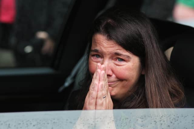 John Hume's daughter Dr. Aine Abbott acknowledges the the support of people as they applaud the passing funeral cortege. (PressEye)