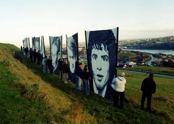 Portraits of the Bloody Sunday victims overlooking the city in 2011.