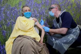 Dr Michael McKenna administer’s a vaccination to 94 year old Eileen Lynch in west Belfast this afternoon. 

Picture by Kelvin Boyes / Press Eye