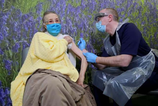 Dr Michael McKenna administer’s a vaccination to 94 year old Eileen Lynch in west Belfast this afternoon.
Picture by Kelvin Boyes / Press Eye