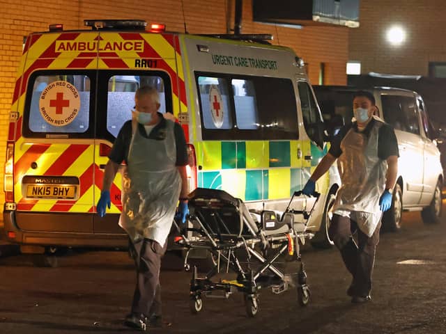 Medical staff return a bed to an ambulance at Antrim Area Hospital, Co Antrim in Northern Ireland recently.