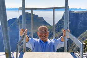 Gregg Wallace climbs a ladder to the top of the cable car station on Table Mountain in Cape Town, 


South Africa