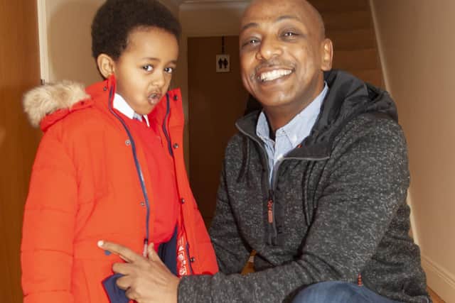 Dr. Abelmoniem Ahmed gets his 4 years-old son Ashruf ready for school on Friday morning at their home.