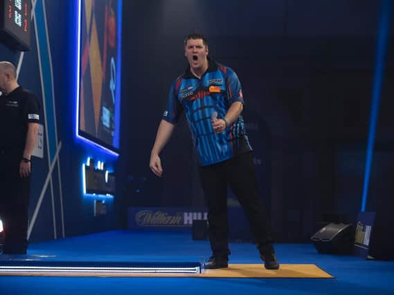 Daryl Gurney in action against eventual world champions, Gerwyn Price at the PDC World Darts Championships quarter-finals at Alexandra Palace.