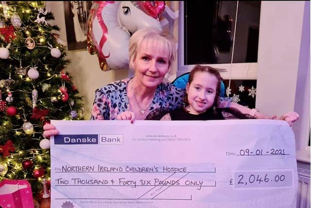 Paula McCallion, from Kylemore Park, and her granddaughter Seanain pictured with a cheque for £2046 recently presented to the Northern Ireland Children’s Hospice.