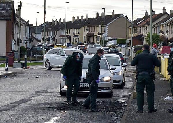 PSNI officers in Creggan Heights, on Saturday morning, at the scene a paramilitary-style shooting and burning of a car on Friday night. DER2102GS â€“ 027