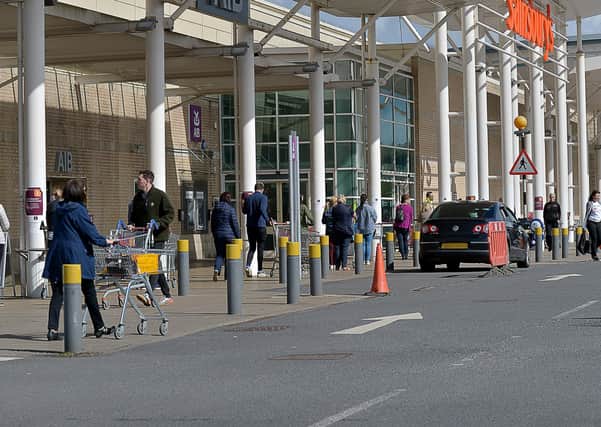Shoppers observe social distancing queuing at Sainsbury’s supermarket, Stand Road, at the weekend. DER1920GS - 015