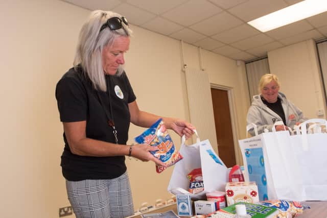 May 2020: Michelle McAdams from Ballyarnett Coummunity Support Team redistributes some of the food boxes for residents of the local area. Picture Martin McKeown. 07.05.20
